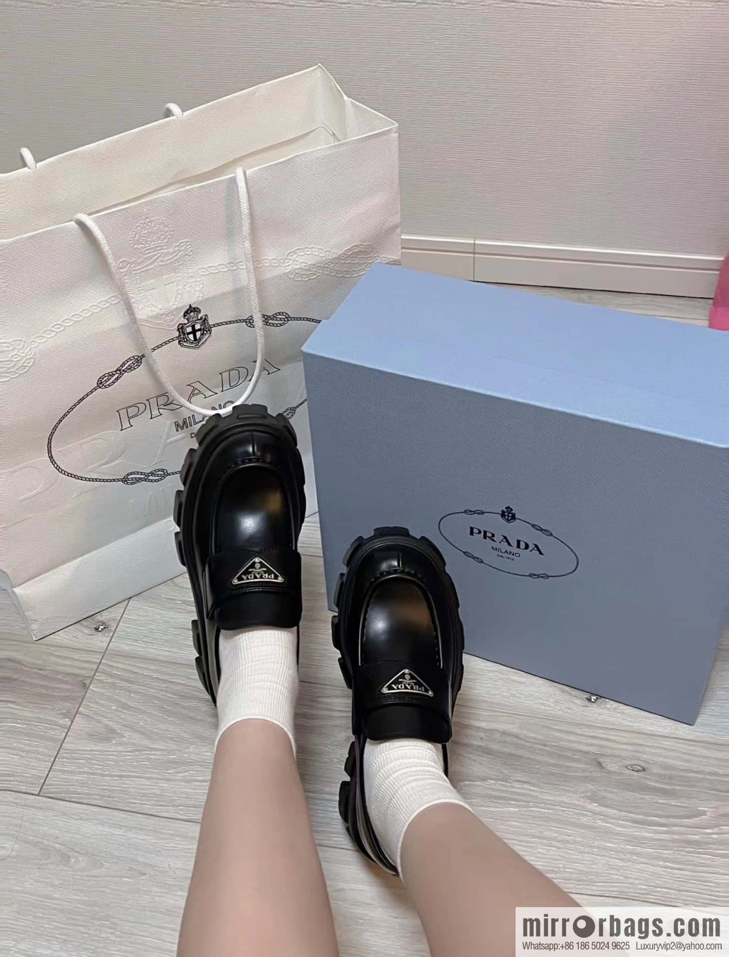 PRADA Prada, triangular label, serrated wheel muffin platform loafers 1D246M