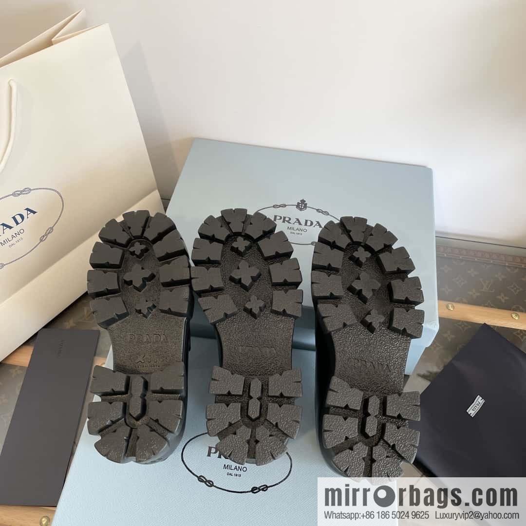 PRADA Prada, triangular label, serrated wheel muffin platform loafers 1D246M