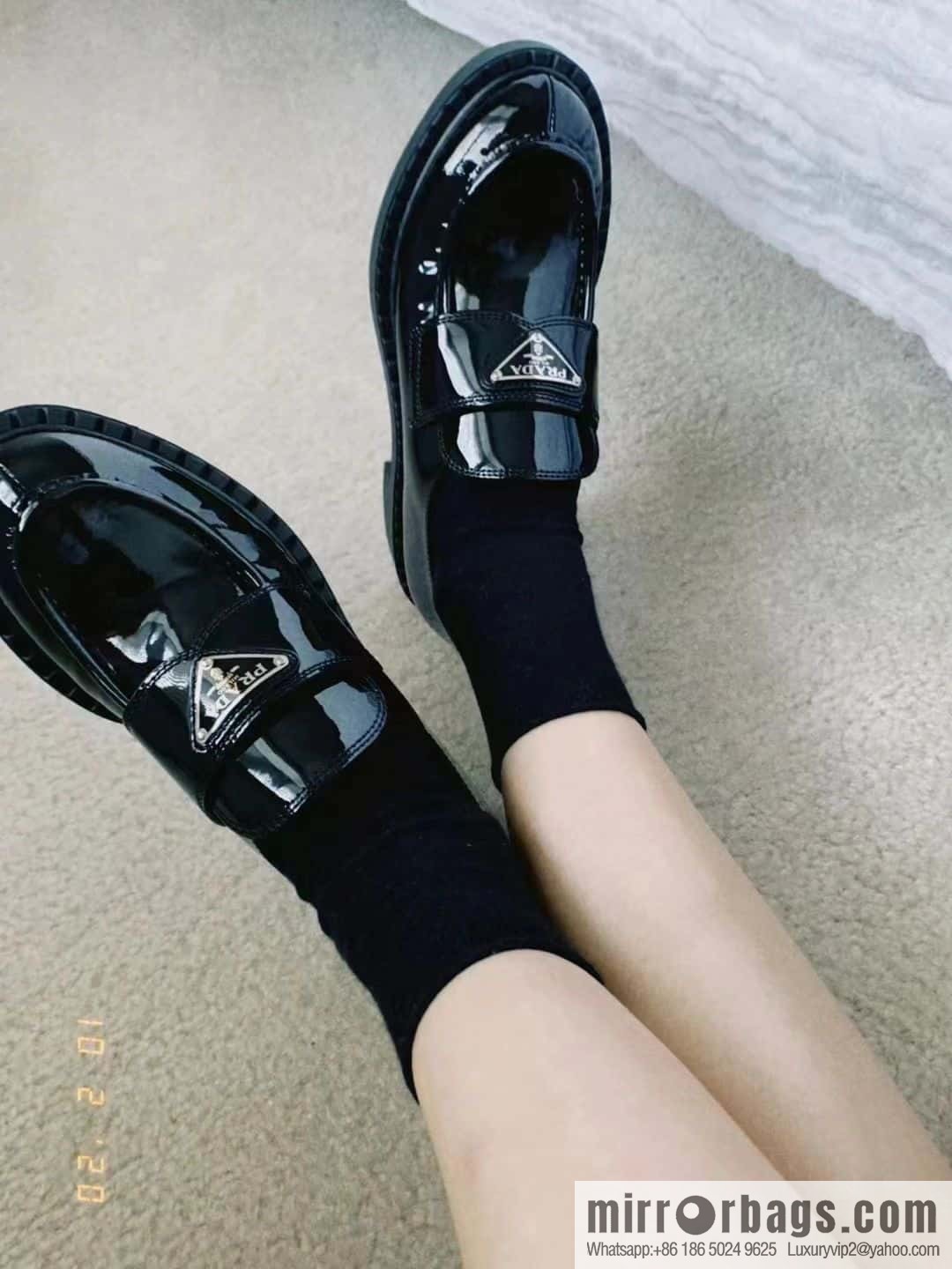 Prada, Puhada glossy patent leather triangle loafers